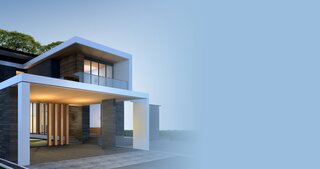 Modern house facade with minimalist design in dark and white tones, warm lighting and a well-kept front garden